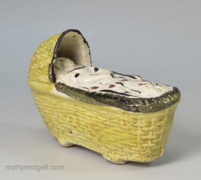 Pearlware pottery baby in a cradle toy, circa 1820