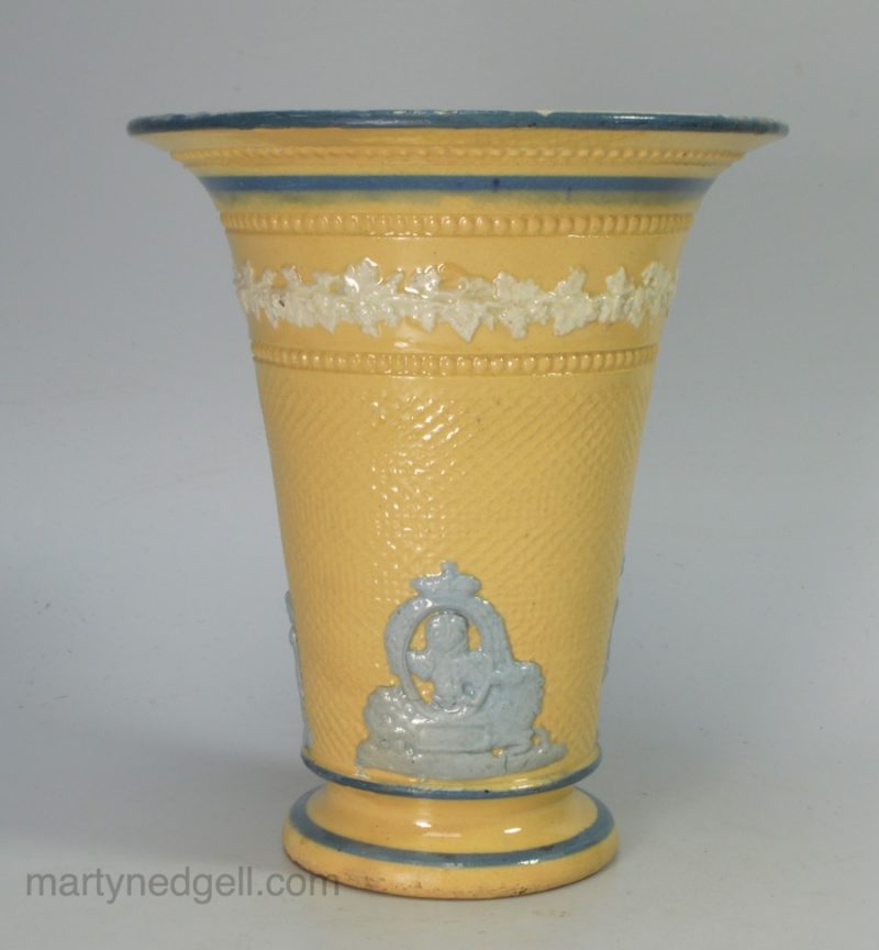 Buff coloured pottery spill vase decorated with blue sprigs, Prince of Wales, circa 1815