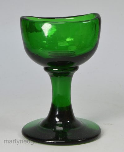 Green glass blown eye bath with polished out pontil mark to the base, circa 1840