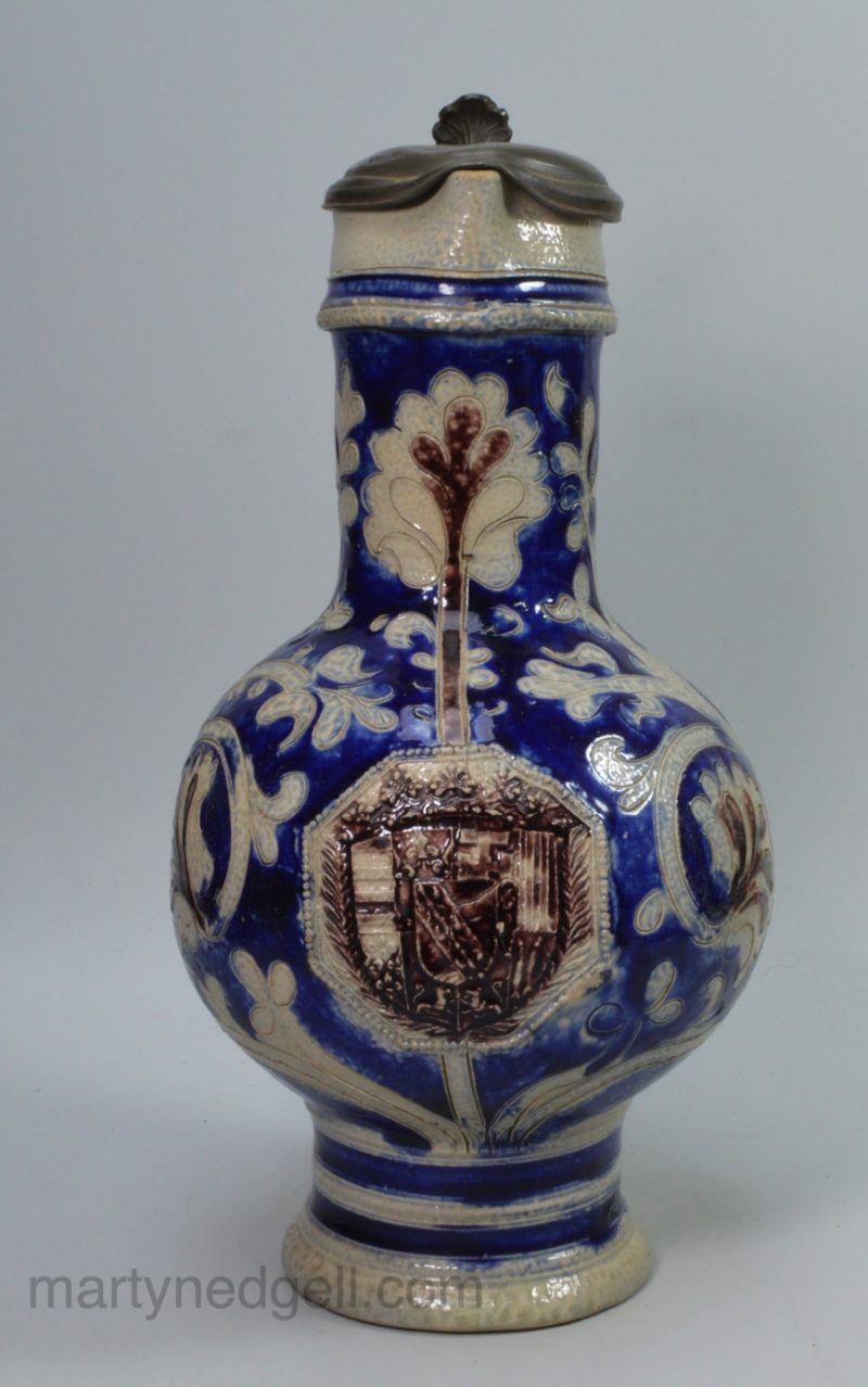 Tall Westerwald saltglaze stoneware jug decorated with a coat of arms, circa 1700
