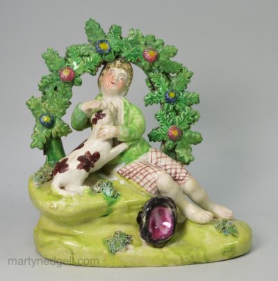 Staffordshire pearlware pottery bocage figure of a boy with his dog, circa 1820
