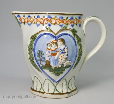Small prattware pottery jug moulded with Sportive Innocence and Mischievous Sport, circa 1820