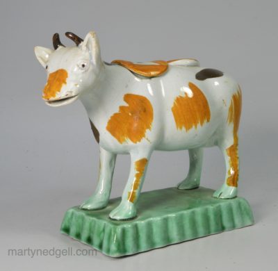 Prattware pottery cow creamer decorated with colours under a pearlware glaze, circa 1820