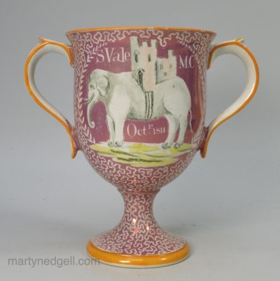 Pearlware pottery loving cup decorated with pink lustre and dated October 1811