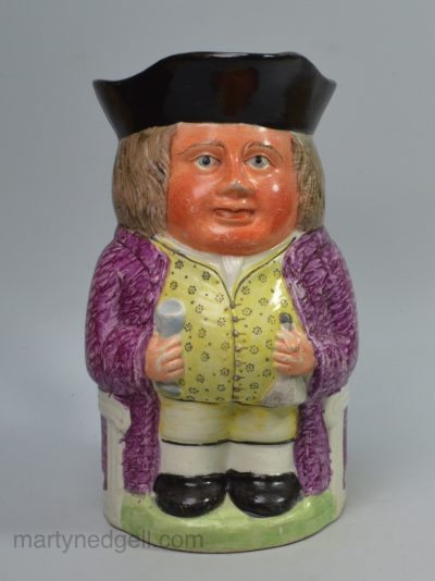 Staffordshire pearlware pottery Toby jug decorated with enamels over the glaze, circa 1820