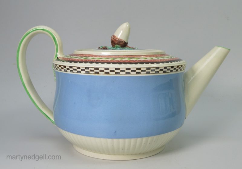 Pearlware pottery teapot decorated with blue slip, inlaid brown and enamels, circa 1810