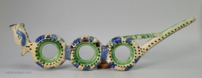 Pearlware pottery novelty pipe decorated with colours under the glaze, circa 1780