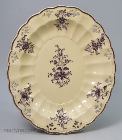 Creamware pottery pierced dish decorated with purple enamelled flowers, circa 1770, one of two available