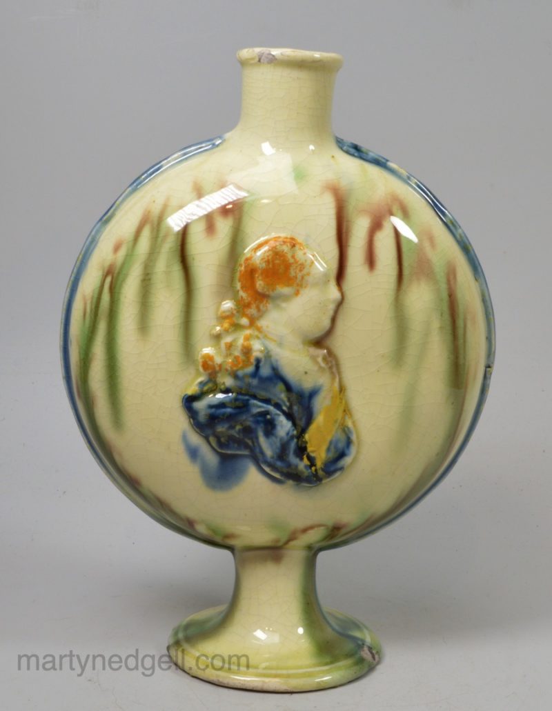 Creamware pottery commemorative flask moulded with George III and Queen Charlotte, circa 1790