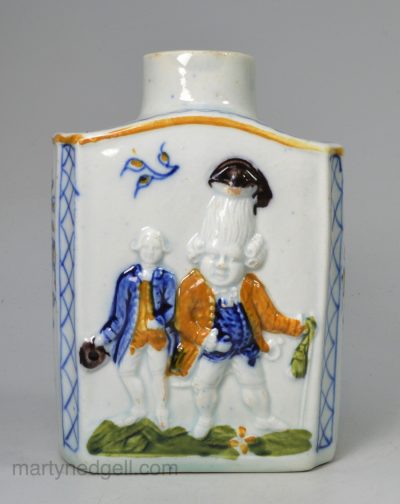 Prattware pottery tea canister moulded with Macaroni figures, circa 1810