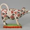 Pearlware pottery cow creamer decorated with over glaze enamels, circa 1830