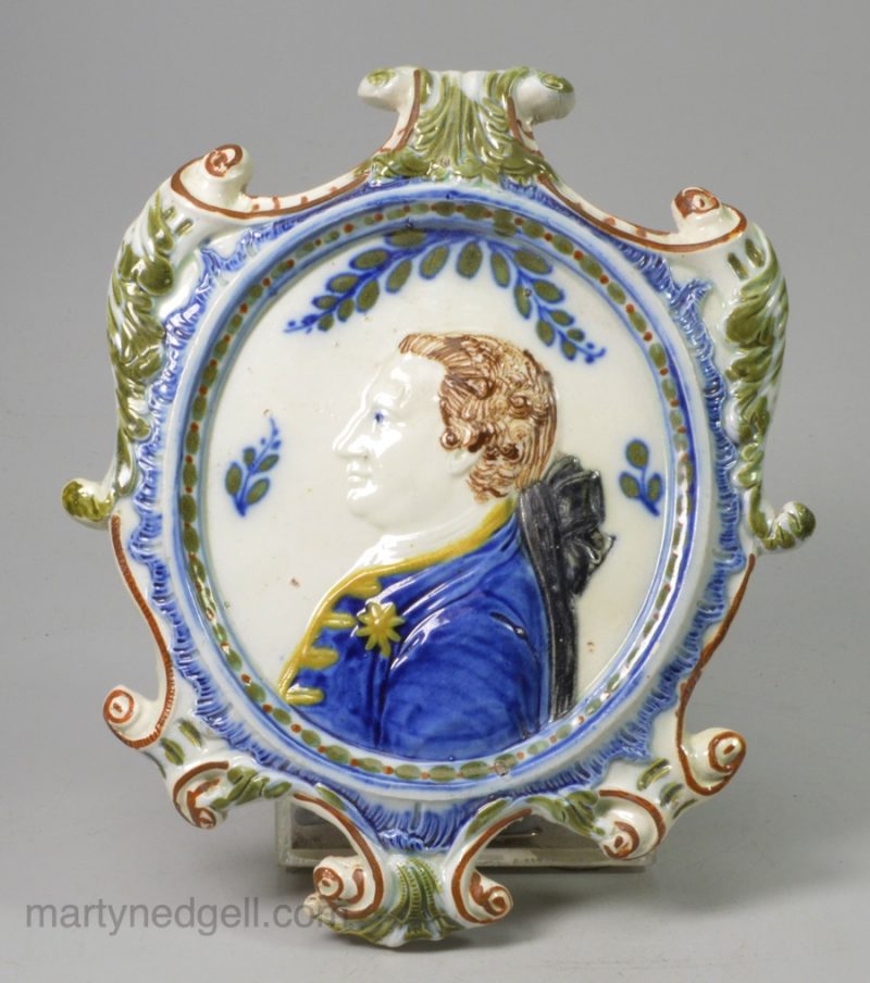 Commemorative prattware pottery plaque, moulded with George III, circa 1800