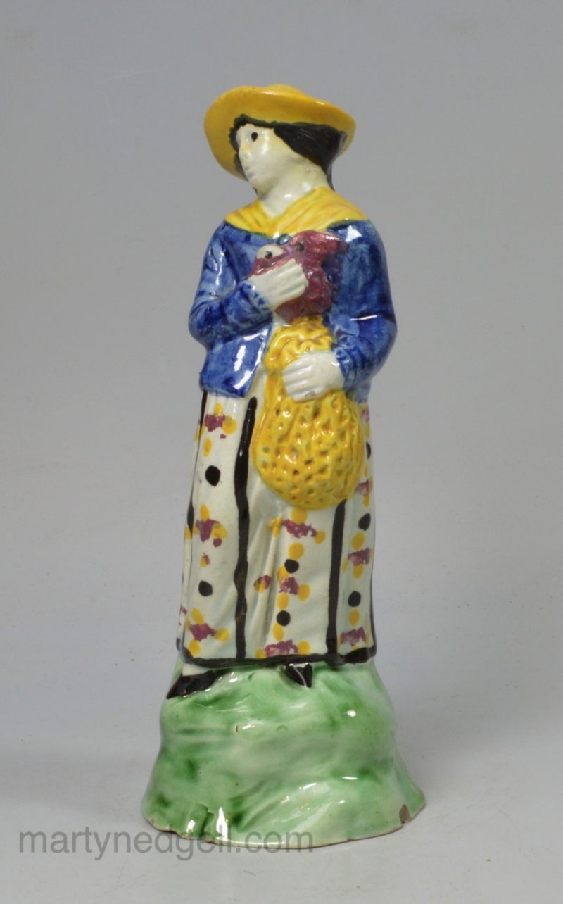 Prattware pottery figure decorated with enamels under a pearlware glaze, circa 1800