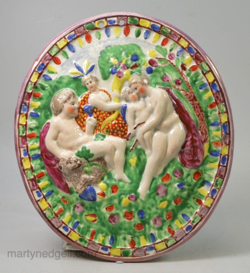 Pearlware pottery plaque moulded with Bacchus and Nymphs, and decorated with overglaze enamels and lustre, circa 1830