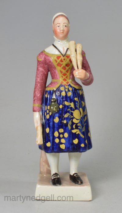 Staffordshire pearlware pottery figure of Madam Vestris in the role of the broom seller decorated with enamels over the glaze, circa 1830