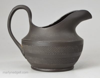 Small black basalt engine turned cream jug, circa 1820
