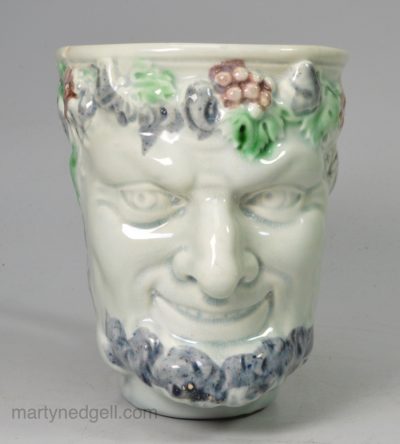 Pearlware pottery Bacchus mug decorated with colours under the glaze, circa 1790