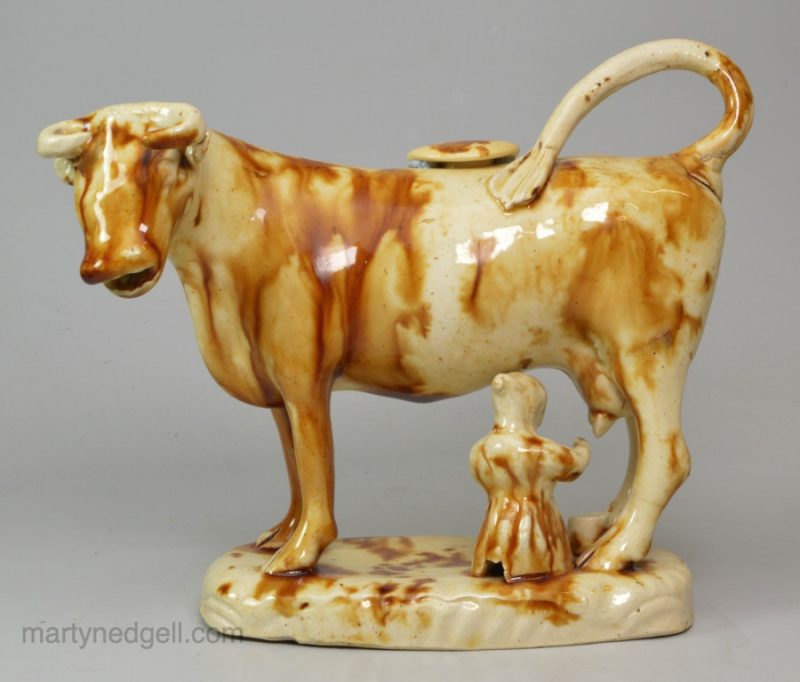 Creamware pottery cow creamer decorated with brown under the glaze, circa 1830