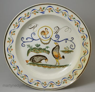 Prattware pottery plate decorated with a cock fighting scene, circa 1820