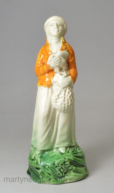 Prattware pottery figure of a woman with a goose, circa 1800