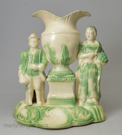 Creamware pottery figural spill vase decorated with green under the glaze, circa 1770