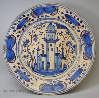 Large Portuguese tin glaze charger, circa 1650 painted with buildings in two colours