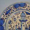Large Portuguese tin glaze charger, circa 1650 painted with buildings in two colours