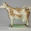Pearlware pottery cow creamer decorated with colours under the glaze, circa 1820