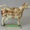 Pearlware pottery cow creamer decorated with colours under the glaze, circa 1820