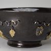 Jackfield black bowl decorated with Tudor rose sprigs and original honey gilding, circa 1760