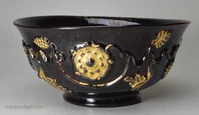 Jackfield black bowl decorated with Tudor rose sprigs and original honey gilding, circa 1760