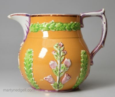 Small pearlware jug decorated with slip, sprigs and pink lustre, circa 1820