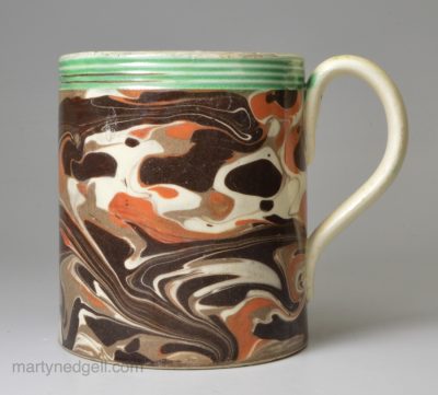 Mochaware mug decorated with curdled slip on creamware pottery, circa 1820