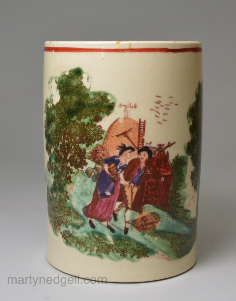 Small creamware pottery mug decorated with a print of a rural scene, circa 1790