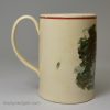 Small creamware pottery mug decorated with a print of a rural scene, circa 1790