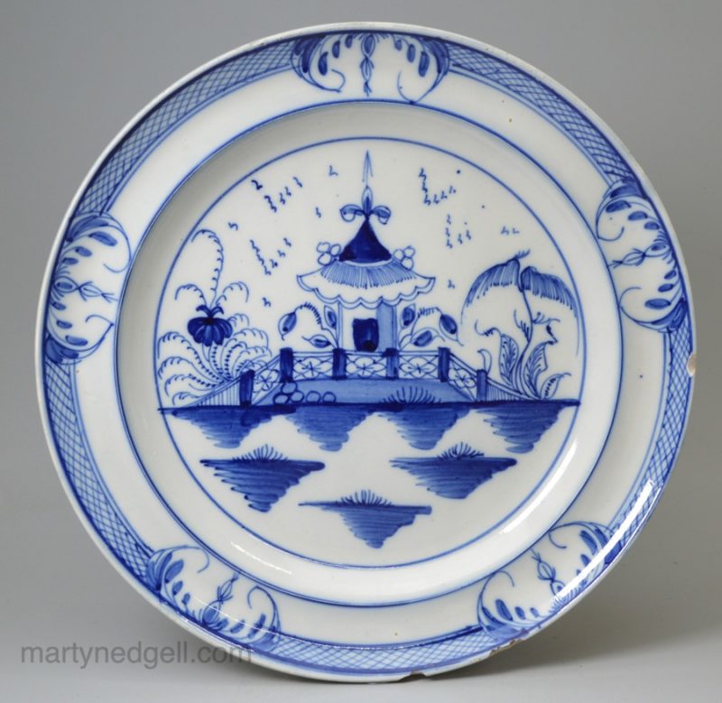 Pearlware pottery plate painted with a pagoda in underglaze blue, circa 1800