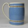 Pearlware pottery mug with light blue slip decoration and inlaid brown checker, circa 1800