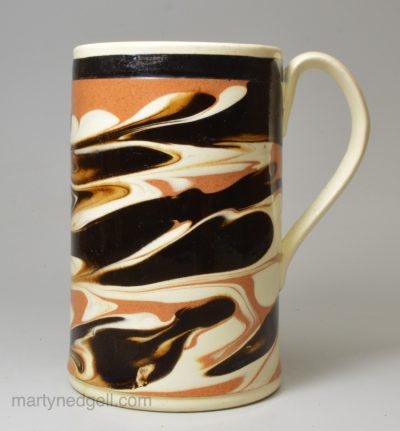 Mochaware mug decorated with slip on a creamware body, circa 1820