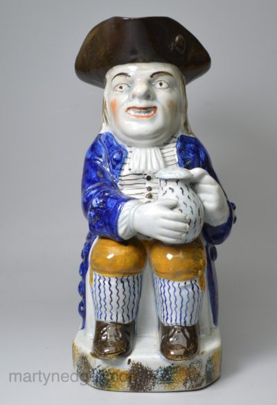 Prattware pottery Toby jug decorated with enamels under a pearlware glaze, circa 1820
