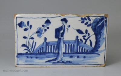 London delft flower brick painted in blue with a Chinese style figure, circa 1750