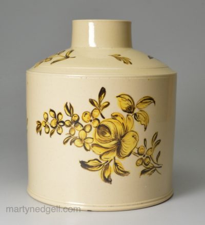 Creamware pottery tea canister painted with yellow flowers over the glaze, circa 1780