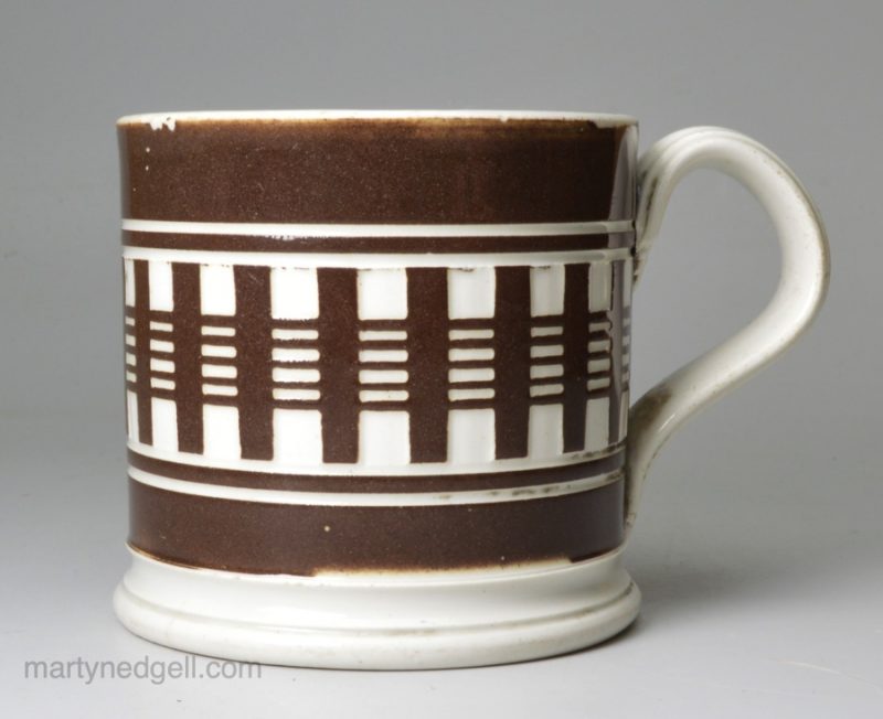 Small mochaware mug, engine turned slip on a pearlware base, circa 1840