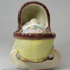 Pearlware pottery toy cradle with young girl, circa 1820