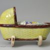 Pearlware pottery toy cradle with young girl, circa 1820