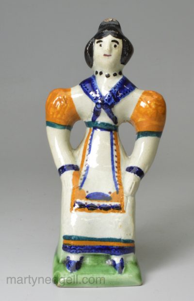 Prattware pottery figure of a seated woman, circa 1800