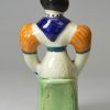 Prattware pottery figure of a seated woman, circa 1800