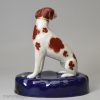 Staffordshire porcelain figure of a chained hound, circa 1840