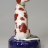 Staffordshire porcelain figure of a chained hound, circa 1840