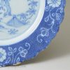 Liverpool delft plate decorated with a chinaman in blue and a powder blue border, circa 1750