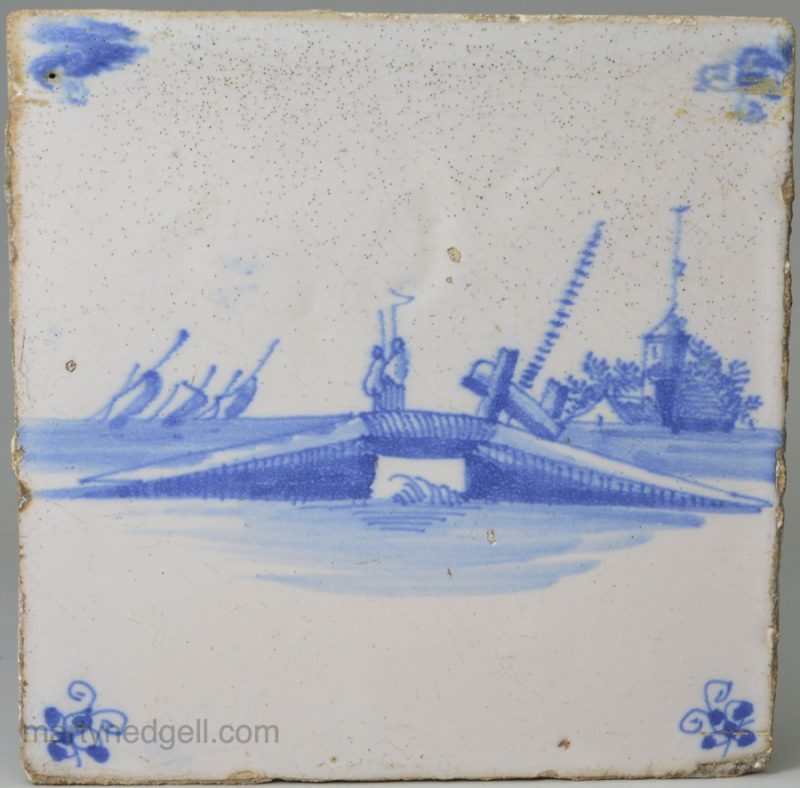 Dutch Delft tile painted with a bridge scene in blue, circa 1750